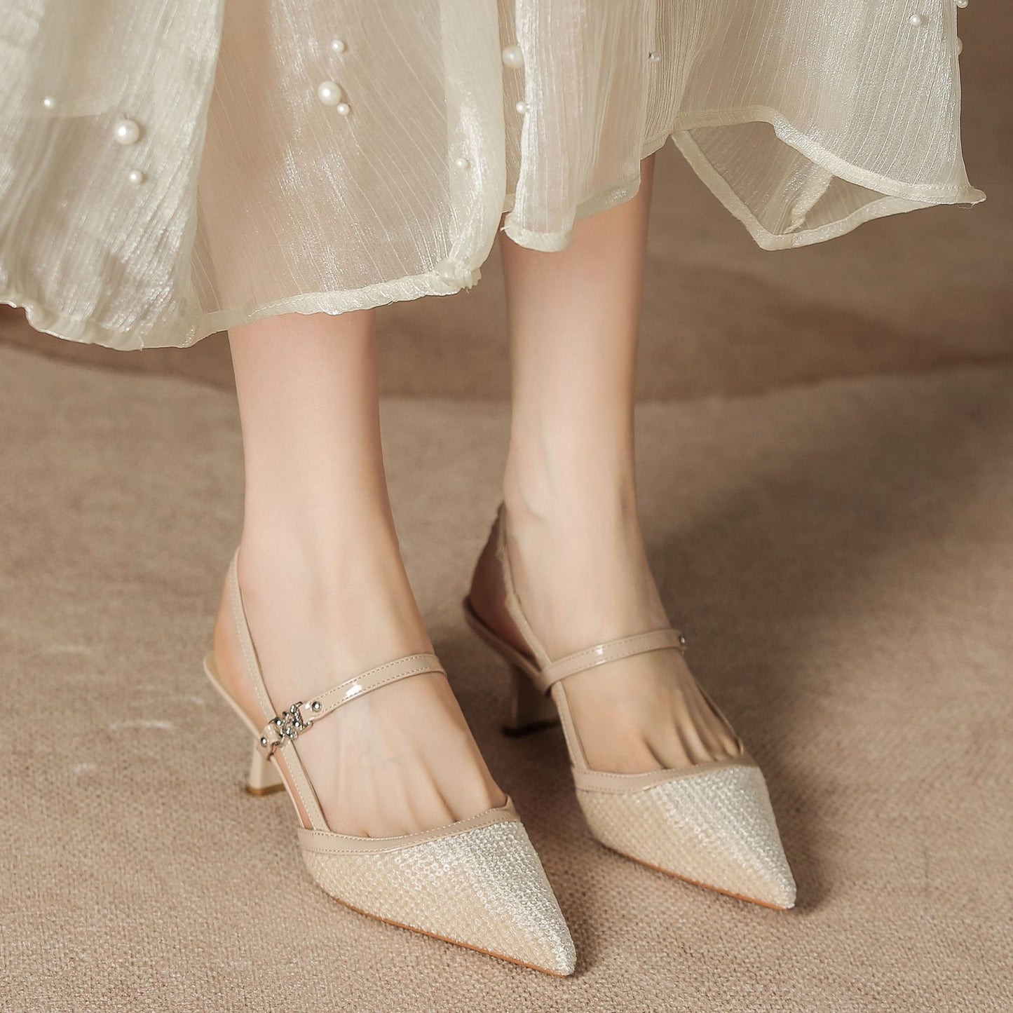 Pointed-toe low-heeled women's shoes with small X-shaped embellishments on the sole